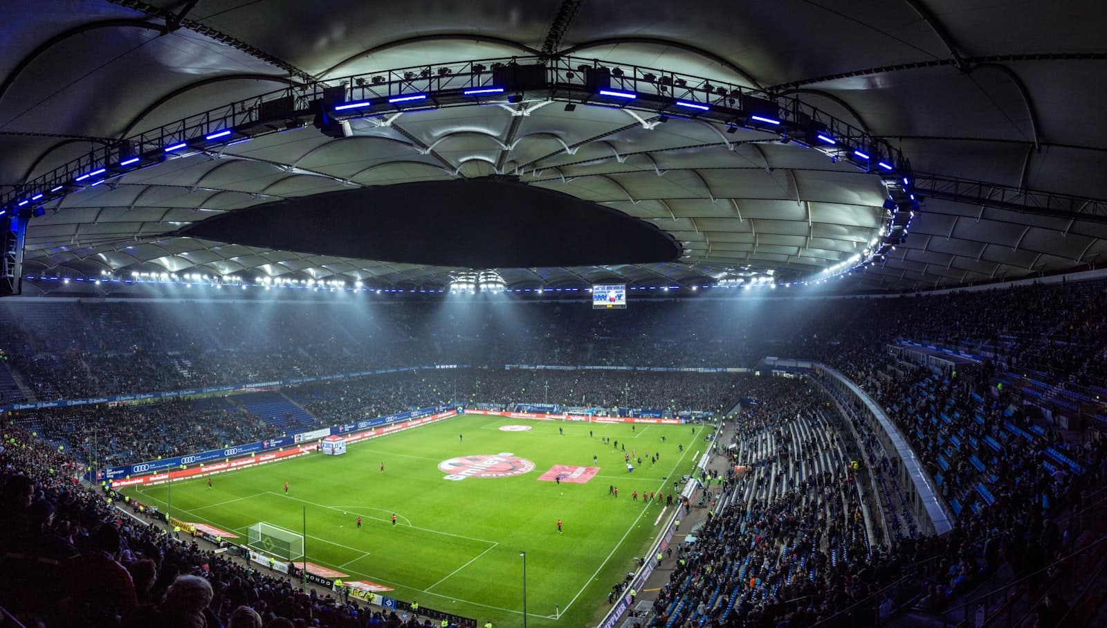 Aerial view of a floodlit football stadium