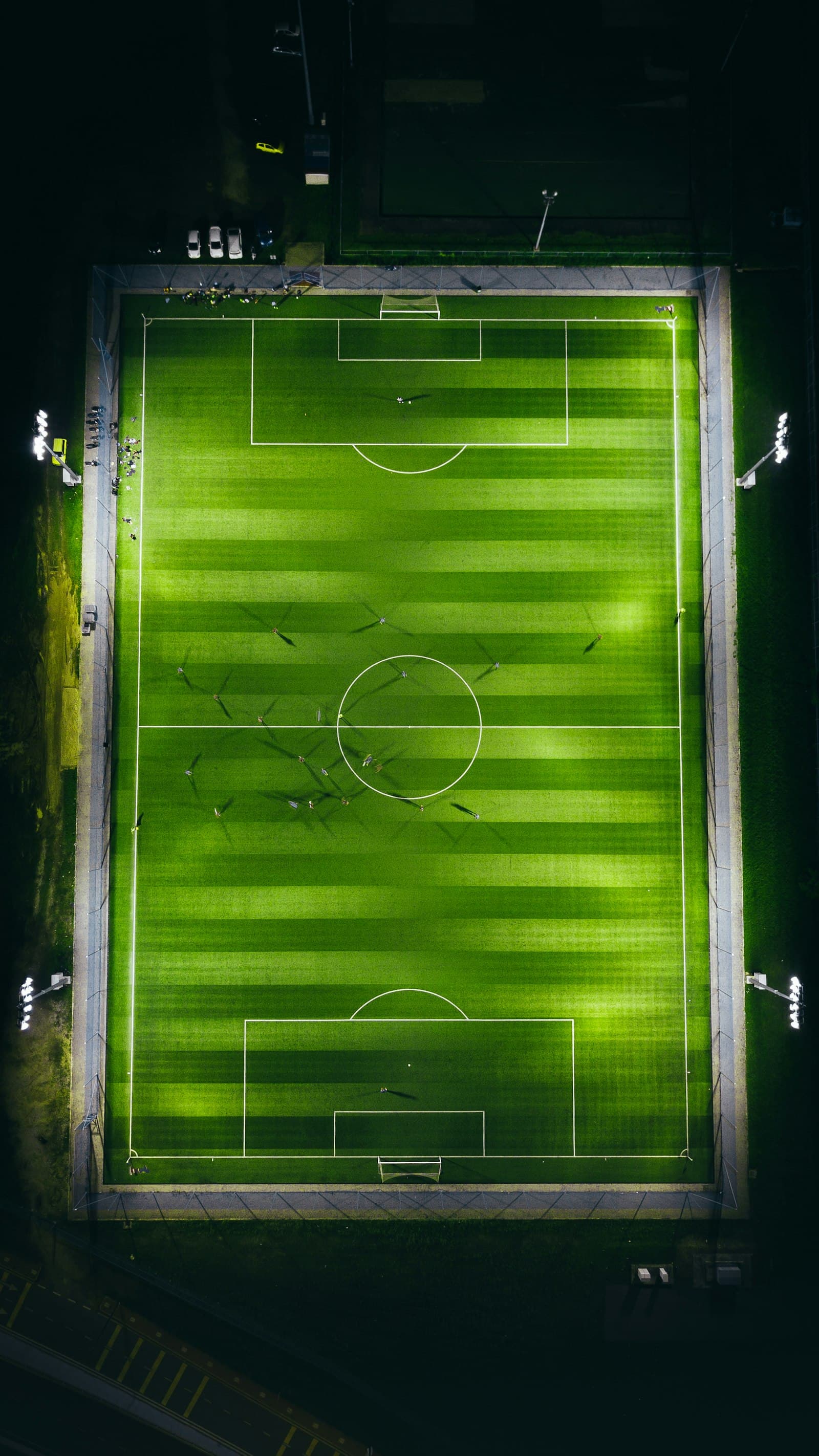 Aerial view of a floodlit soccer field at night