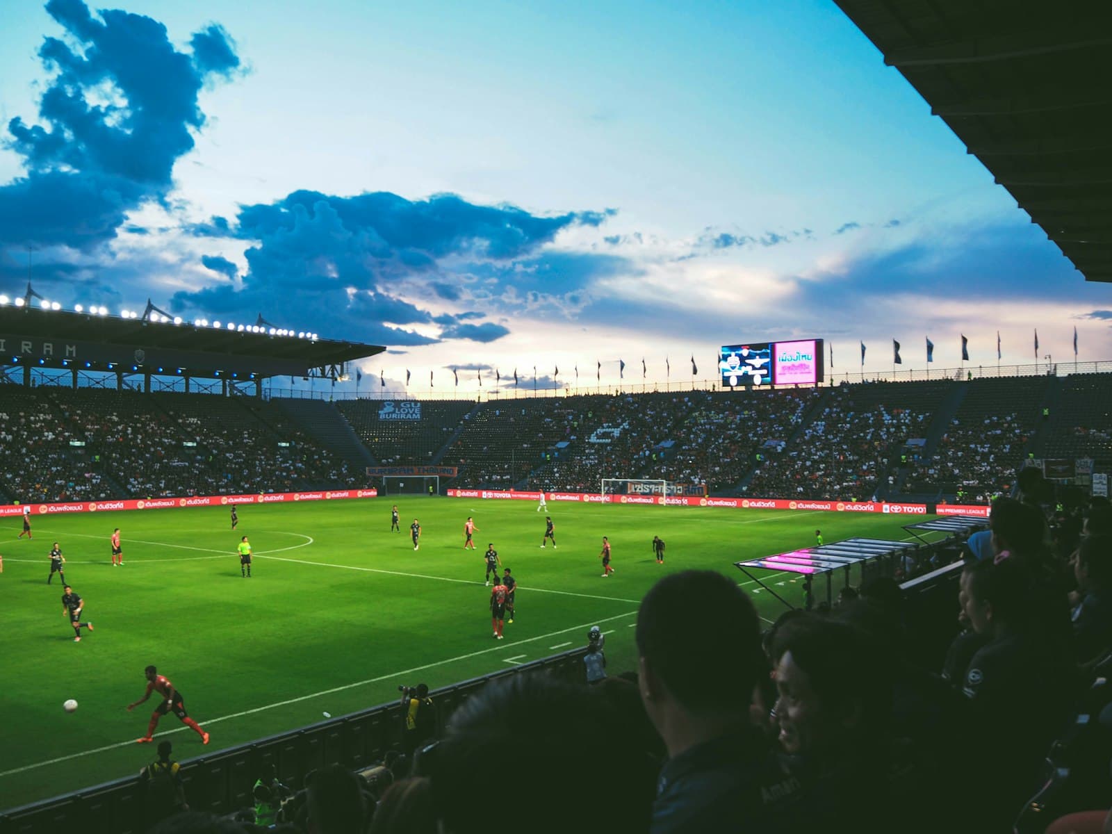 Fans watching a match in a packed stadium